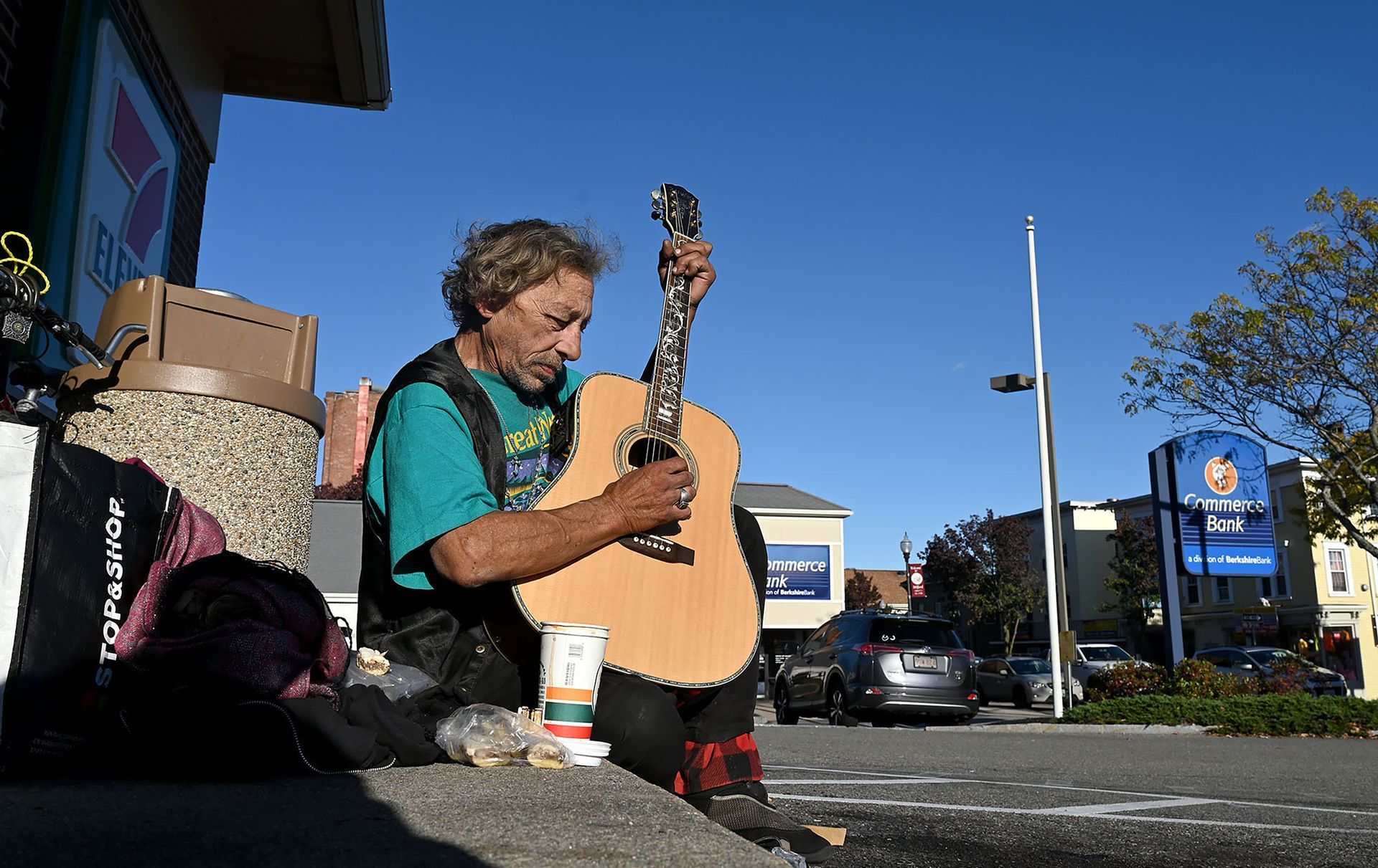 Robert Consoletti of Milford strums on his guitar in front of the 7-Eleven in Milford on Nov. 5, 2021. The self-taught musician said he plays his guitar