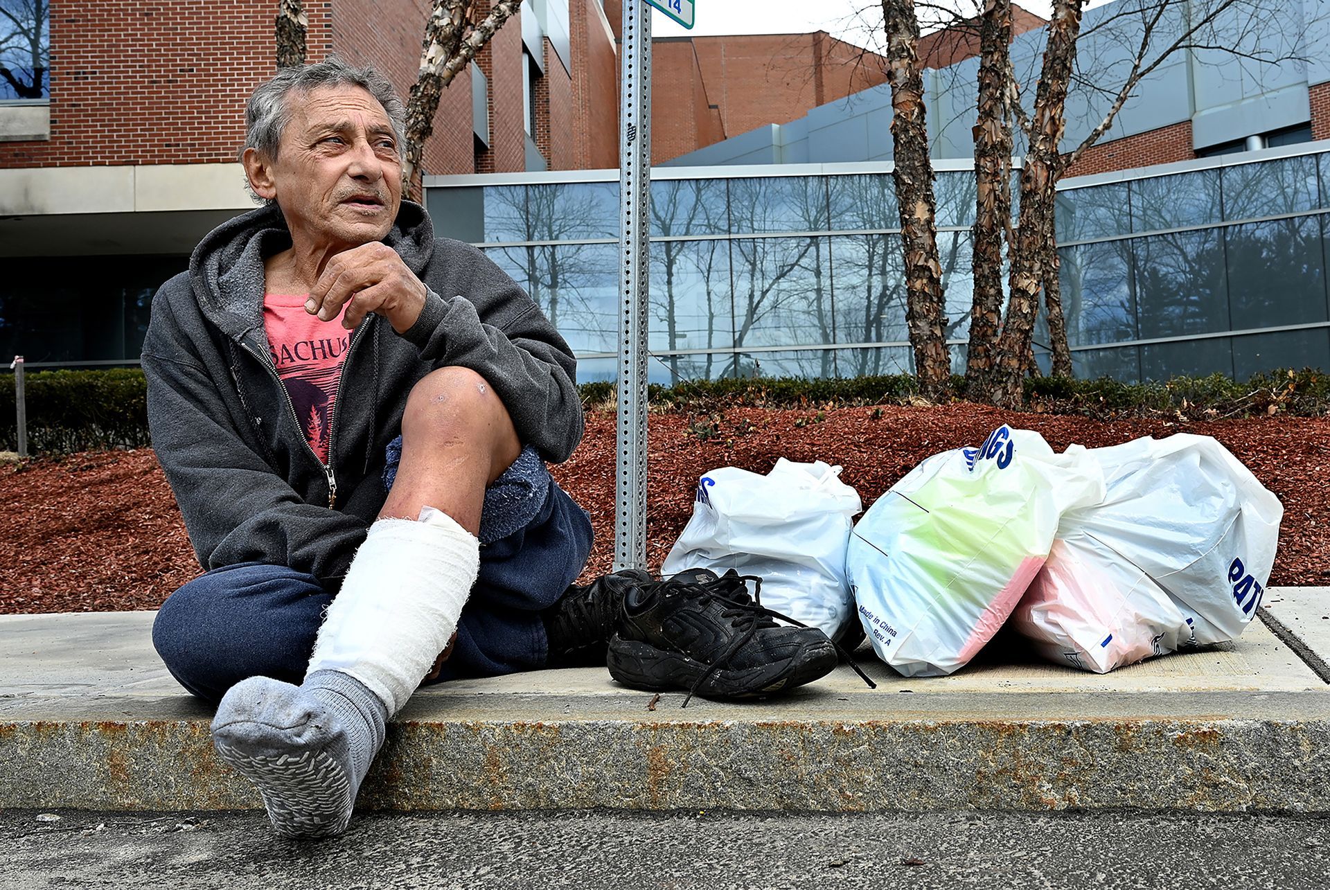 Robert Consoletti of Milford waits for an MWRTA bus after discharge from Milford Hospital, March 25, 2022. He was admitted for a foot infection.