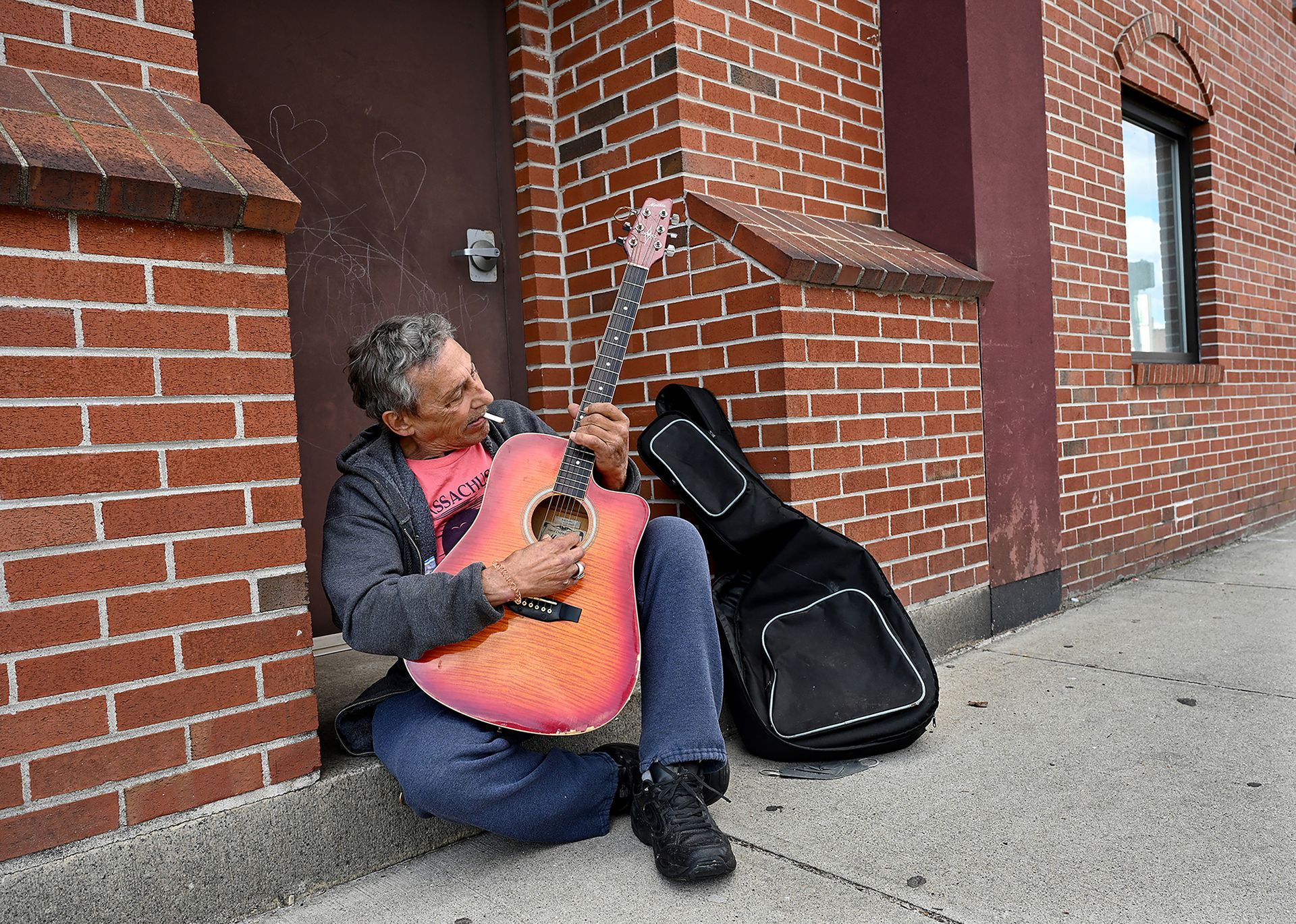 Playing a different guitar and with a new haircut, Robert Consoletti of Milford was back in downtown Milford on March 25, 2022. Consoletti, 67, is a 1972 graduate of Milford High School. The self-taught musician also rolls his own cigarettes.