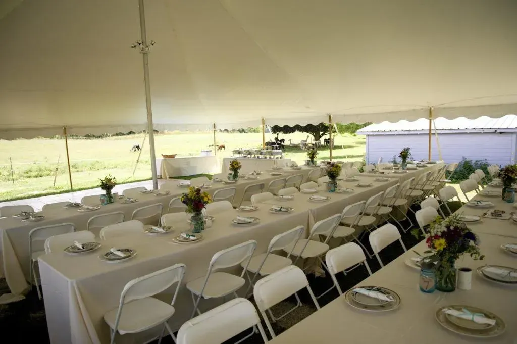 a tent with tables and chairs set up for a party