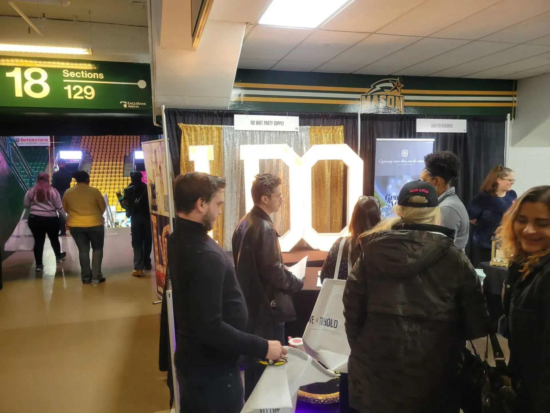 a group of people are standing in front of a sign that says I DO
