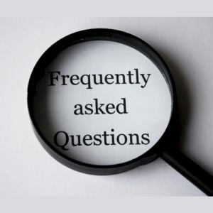 Magnifying glass over the words “Frequently asked Questions” on a white background