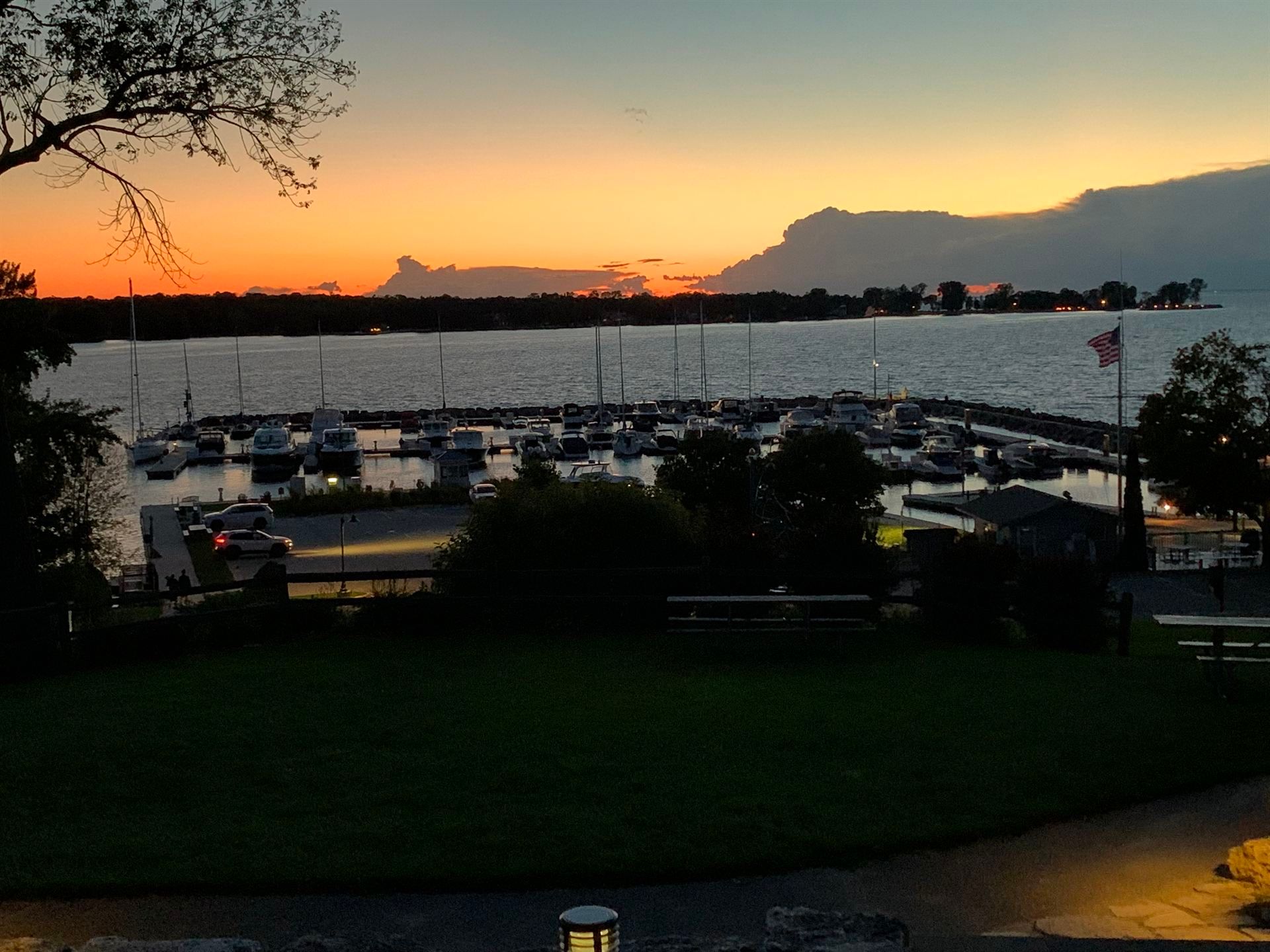 A sunset over a body of water with boats in it