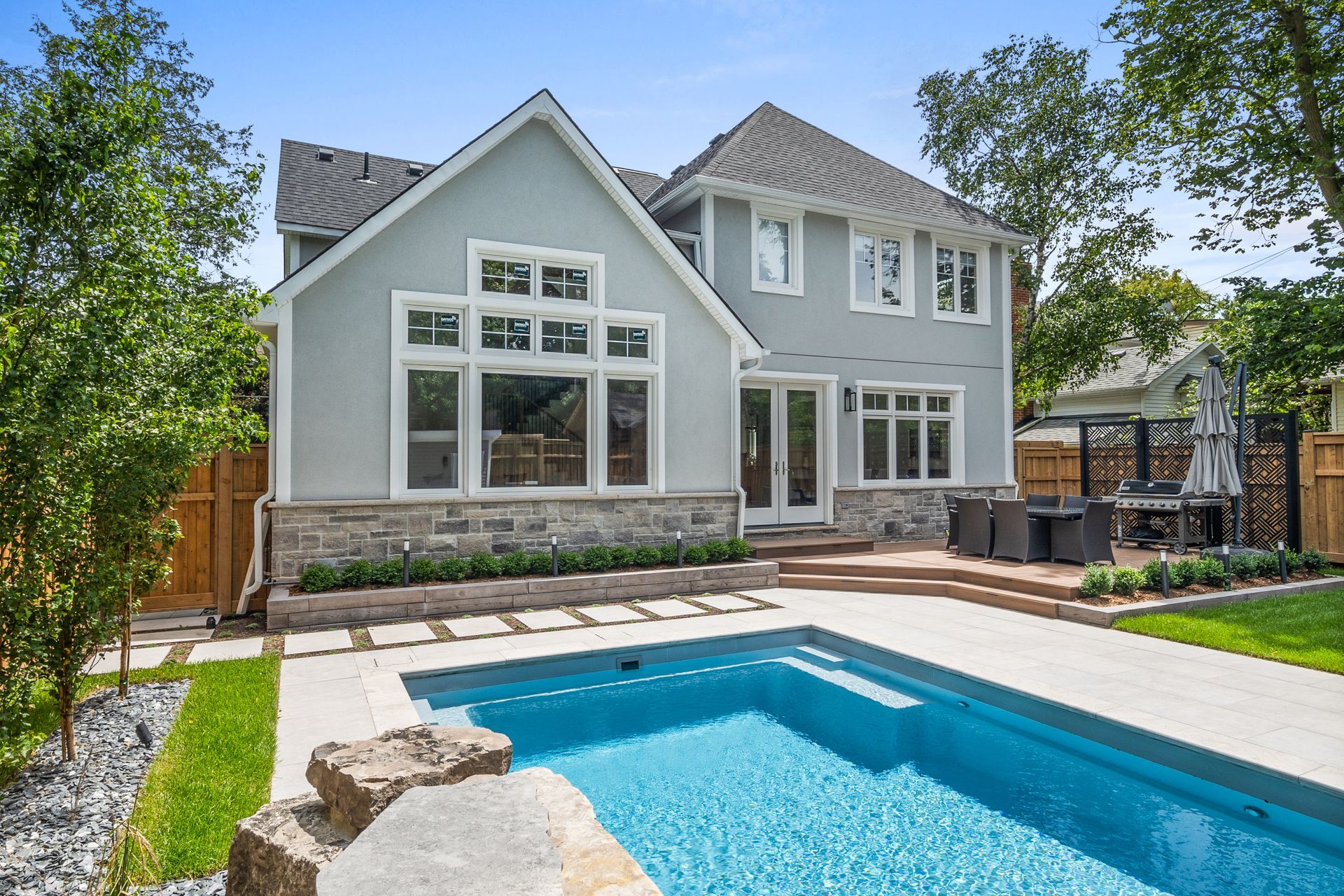 A large house with a large swimming pool in the backyard.