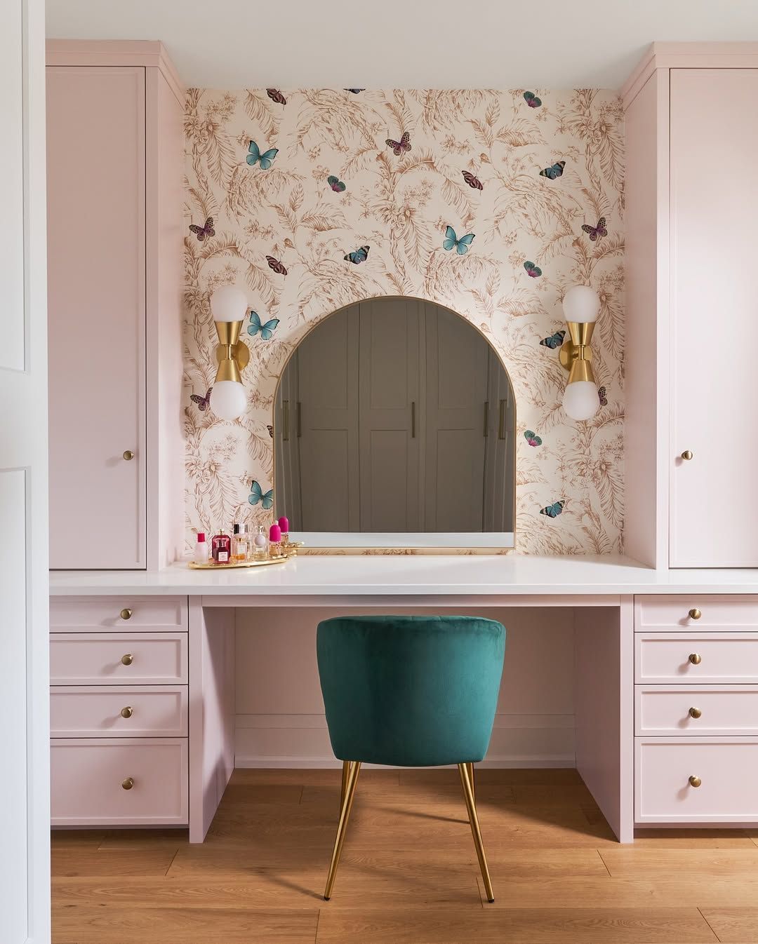 A vanity with a mirror and a chair in front of it
