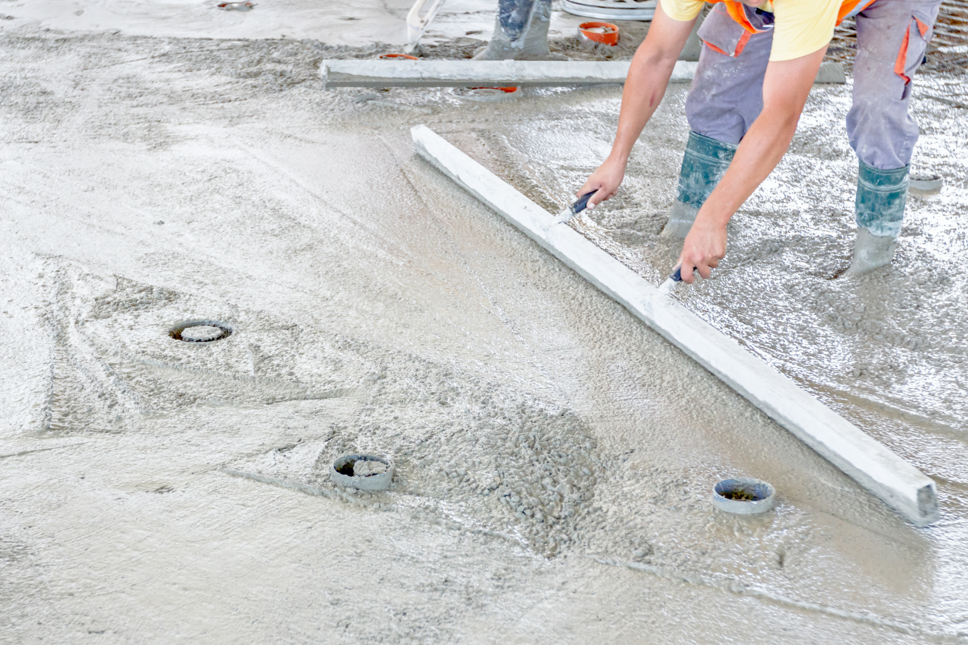 worker leveling concrete in Lehi, Ut