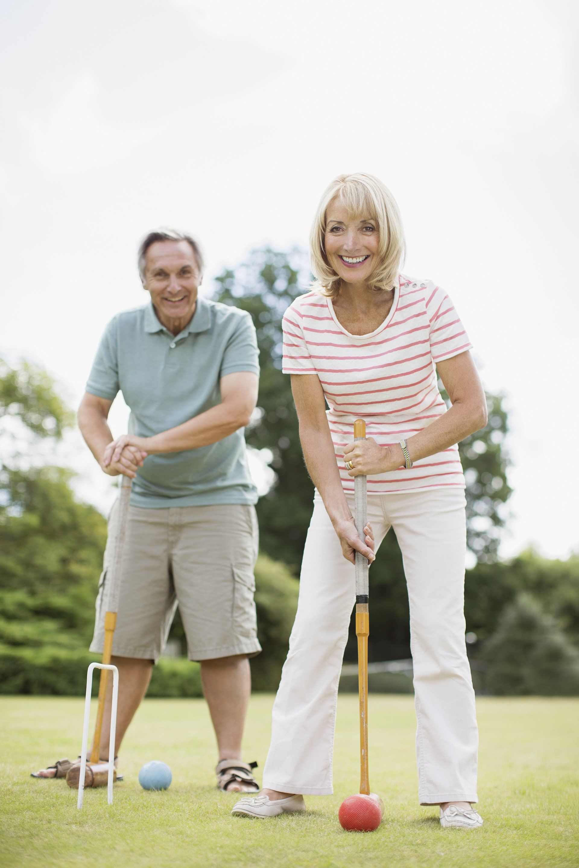 Couple playing croquet