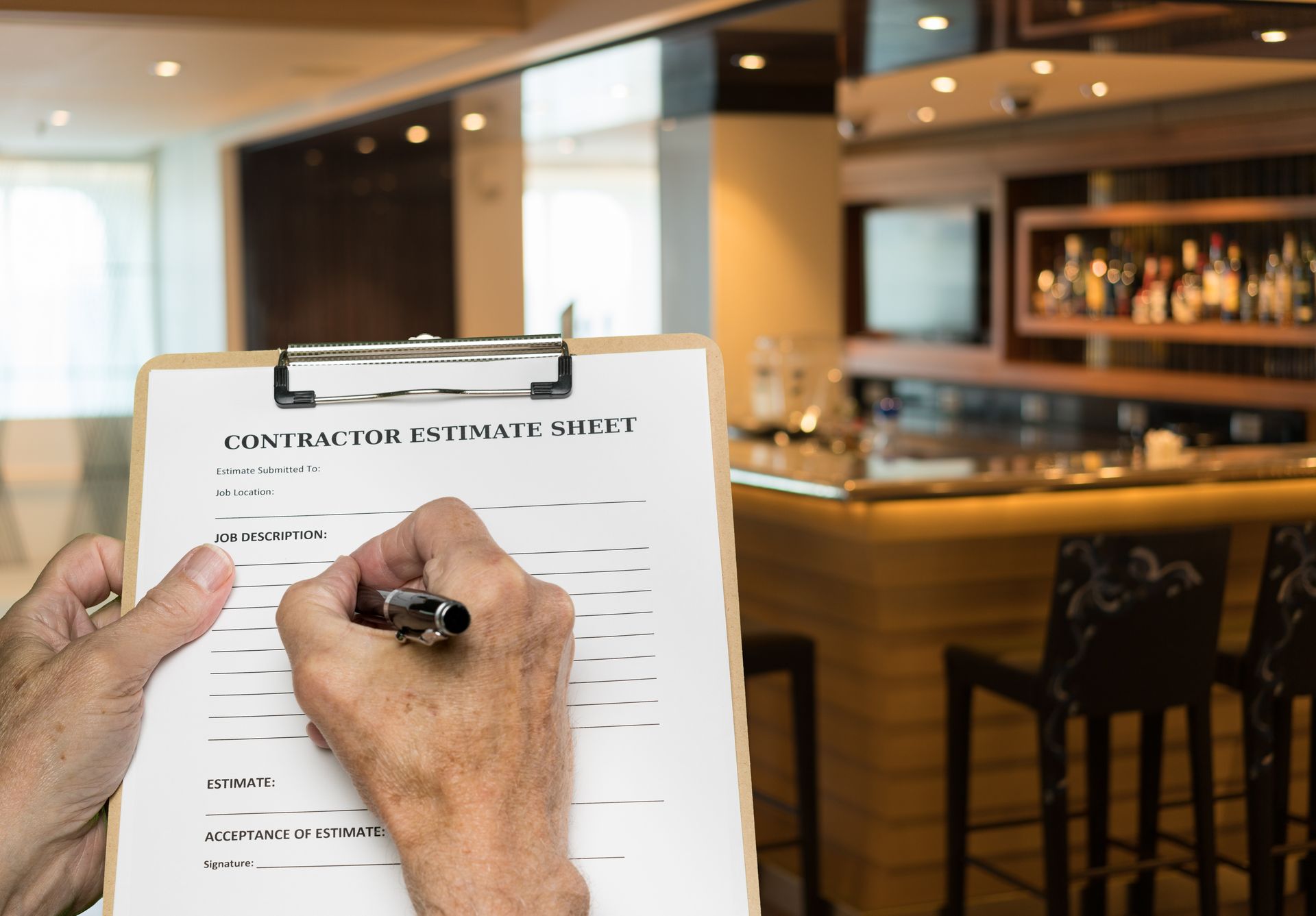 Contractor filling out a budget estimate for a restaurant commercial remodeling project.