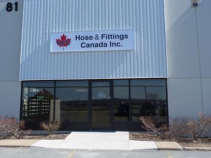 Building entrance with sign for Hose & Fittings Canada Inc., featuring a red maple leaf logo.