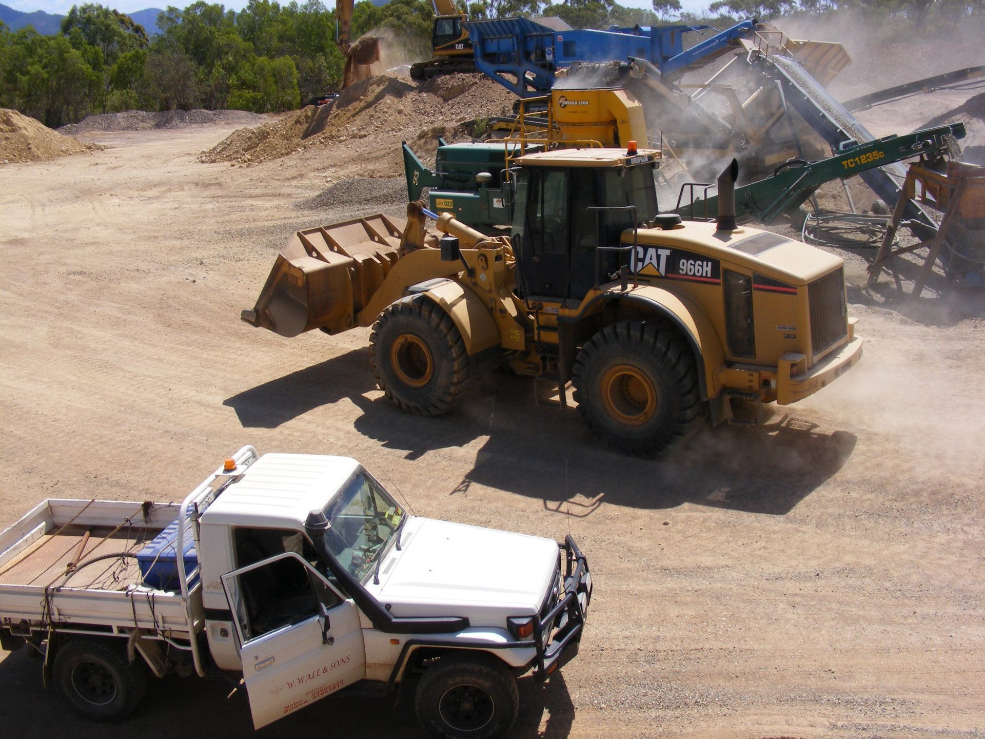 a yellow truck and a white car — W Wall & Sons in Nebo, QLD