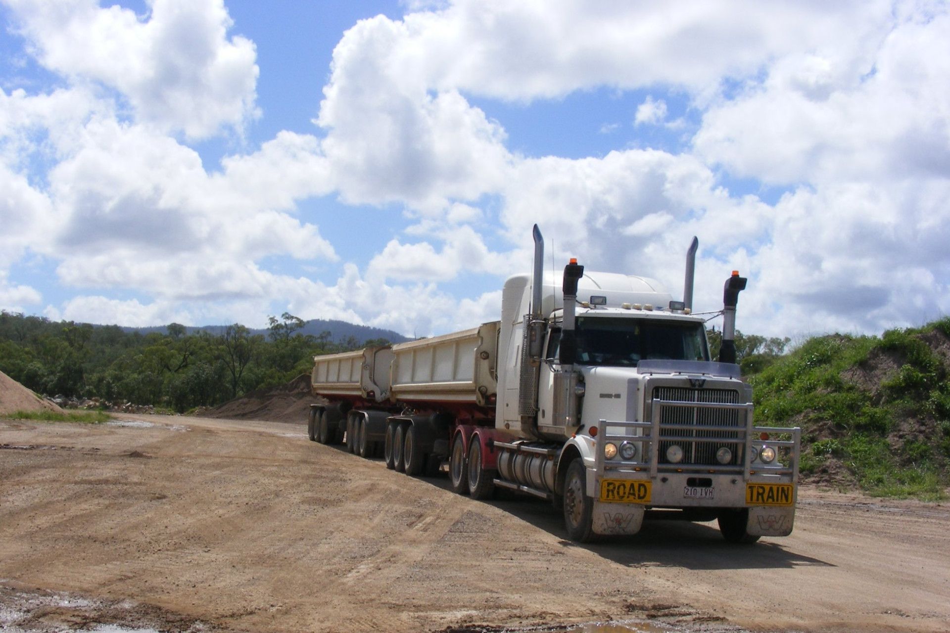 a truck on a dirt road surrounded by grass and trees — W Wall & Sons in Nebo, QLD