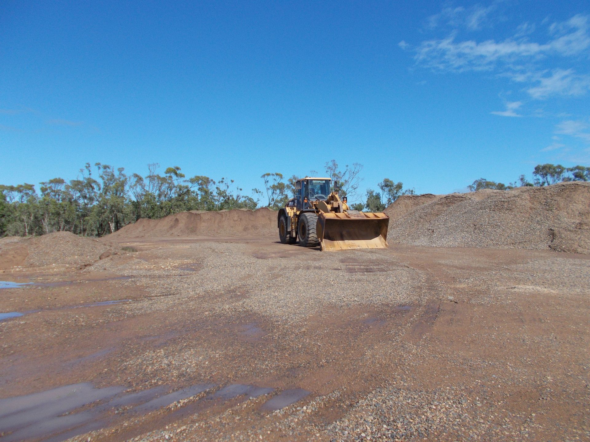 a dirt hill with trees in the background— W Wall & Sons In Proserpine, QLD