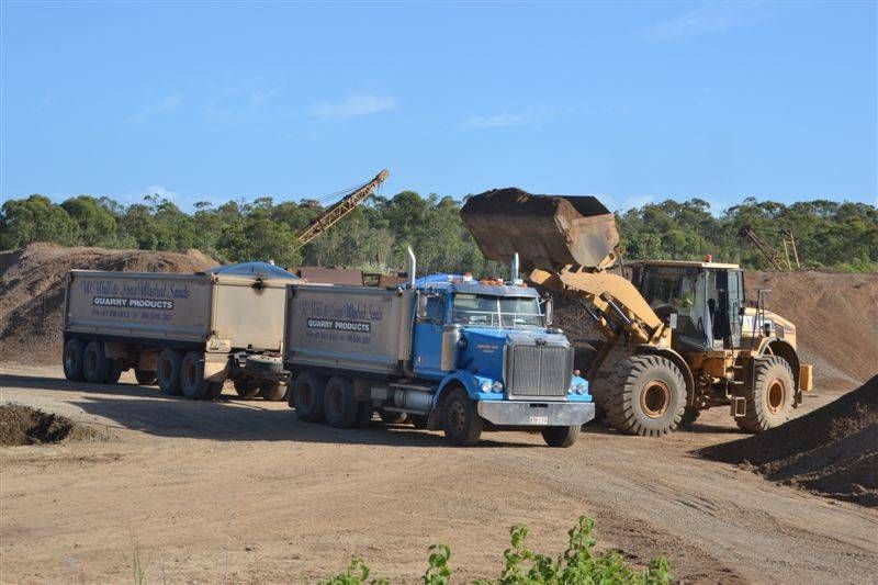 a blue truck with dirt being poured in — W Wall & Sons In Bowen, QLD