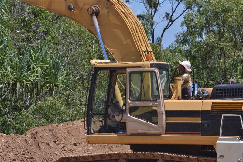 a man is standing in a yellow truck — W Wall & Sons In Mirani, QLD