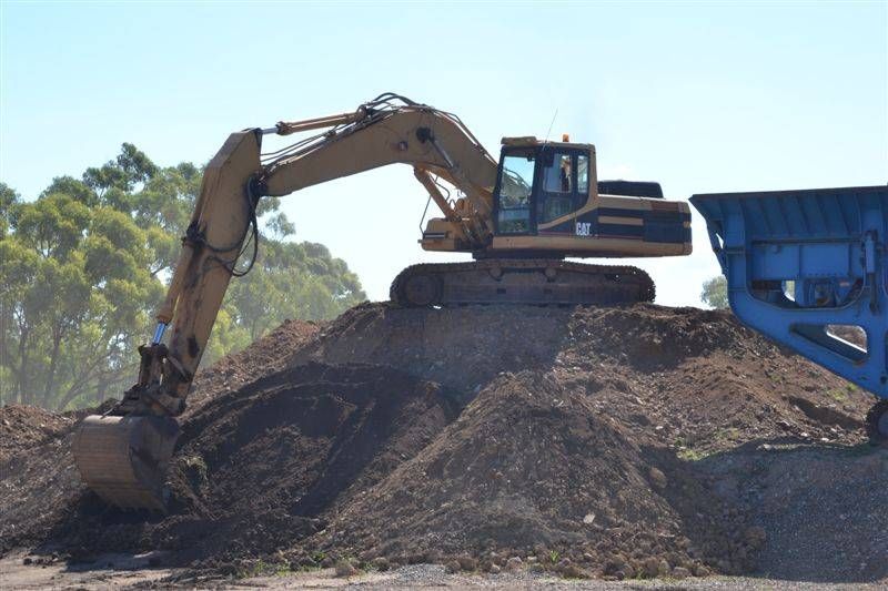 a yellow truck is sitting on dirt— W Wall & Sons in Nebo, QLD