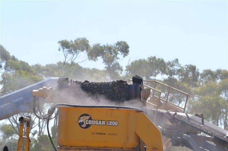rocks are being poured into a yellow truck — W Wall & Sons In Cannonvale, QLD