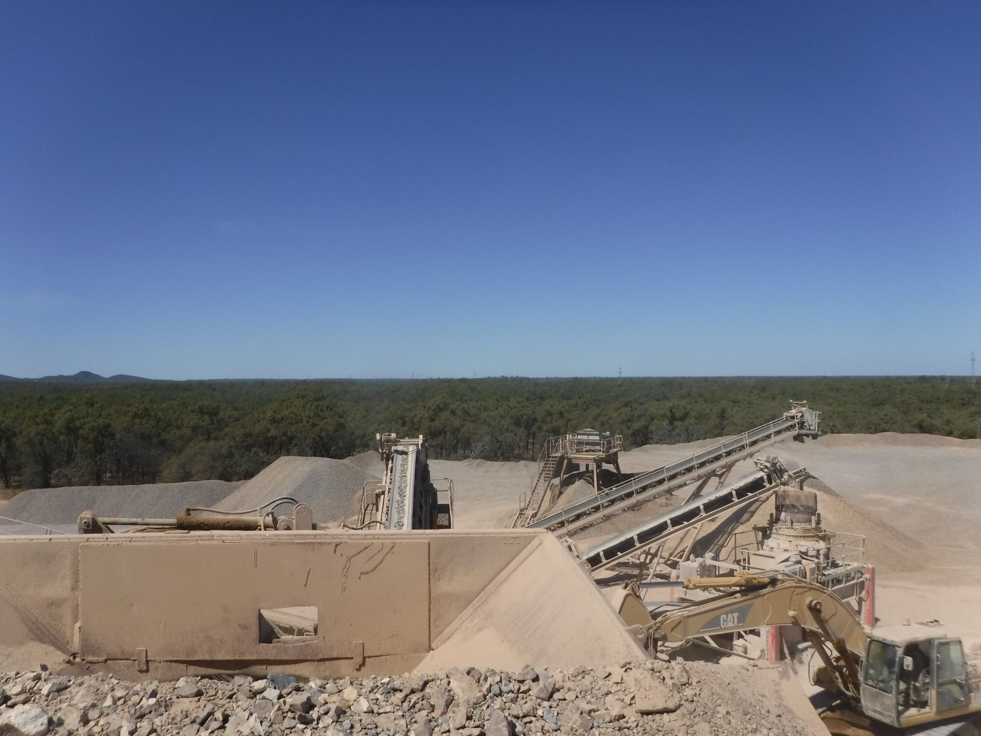 A Yellow Dump Truck Is Dumping Dirt Into A Pile — W Wall & Sons In Dysart, QLD