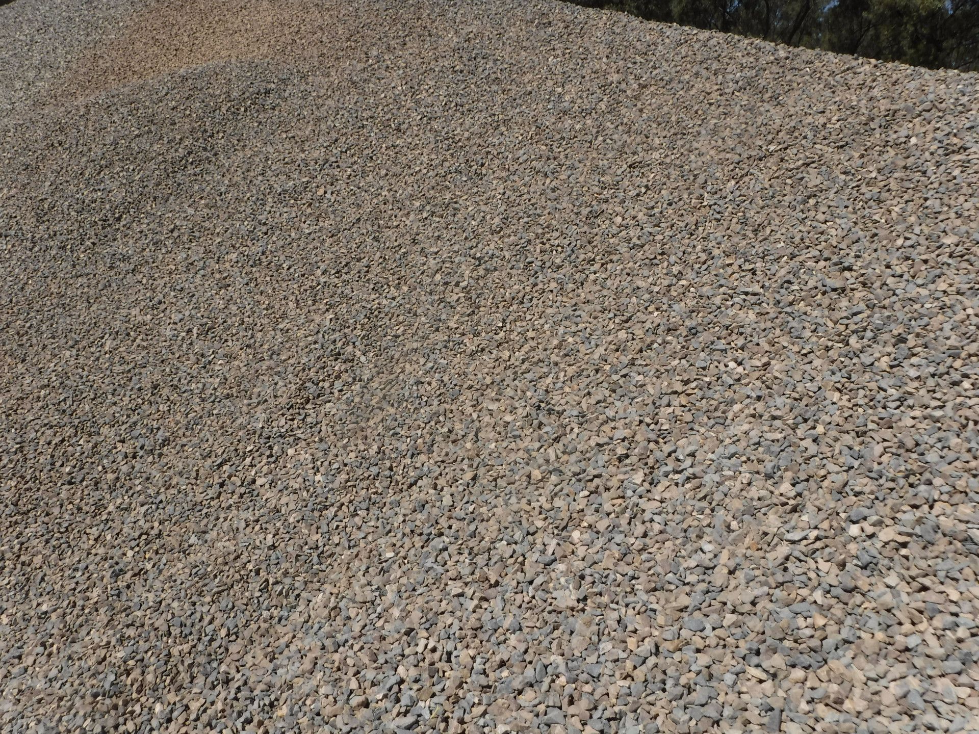 A Concrete Mixer Is Pouring Concrete Into A Bucket — W Wall & Sons In Glenden, QLD