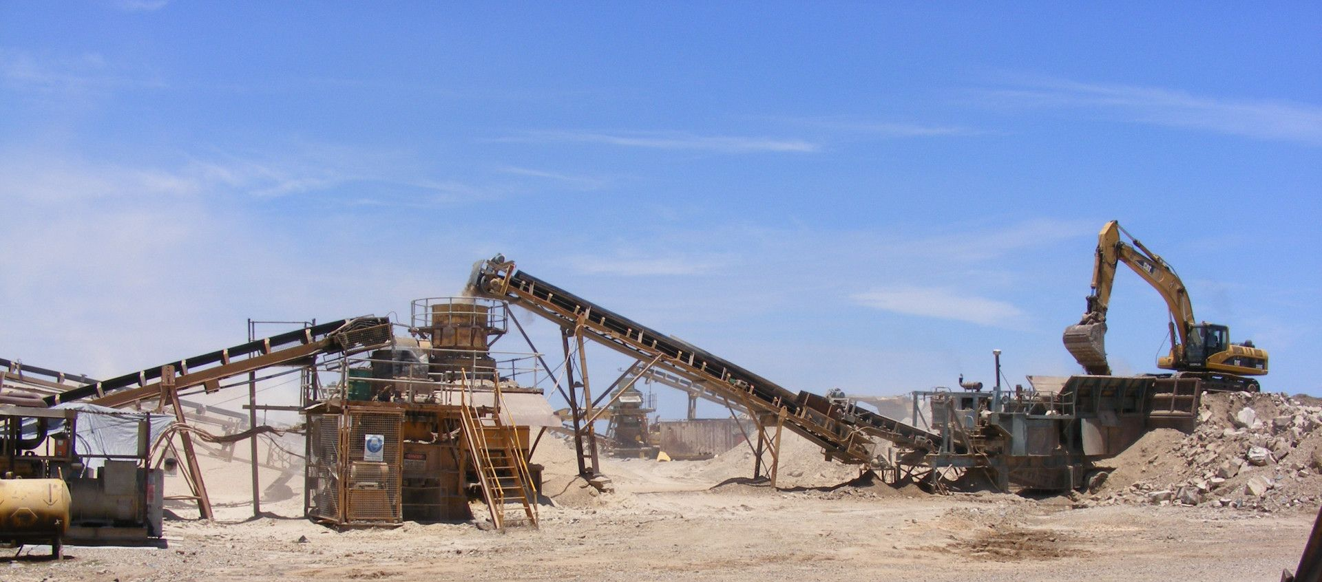 Two Conveyor Belts Are Stacked On Top Of A Pile Of Gravel — W Wall & Sons In Dysart, QLD