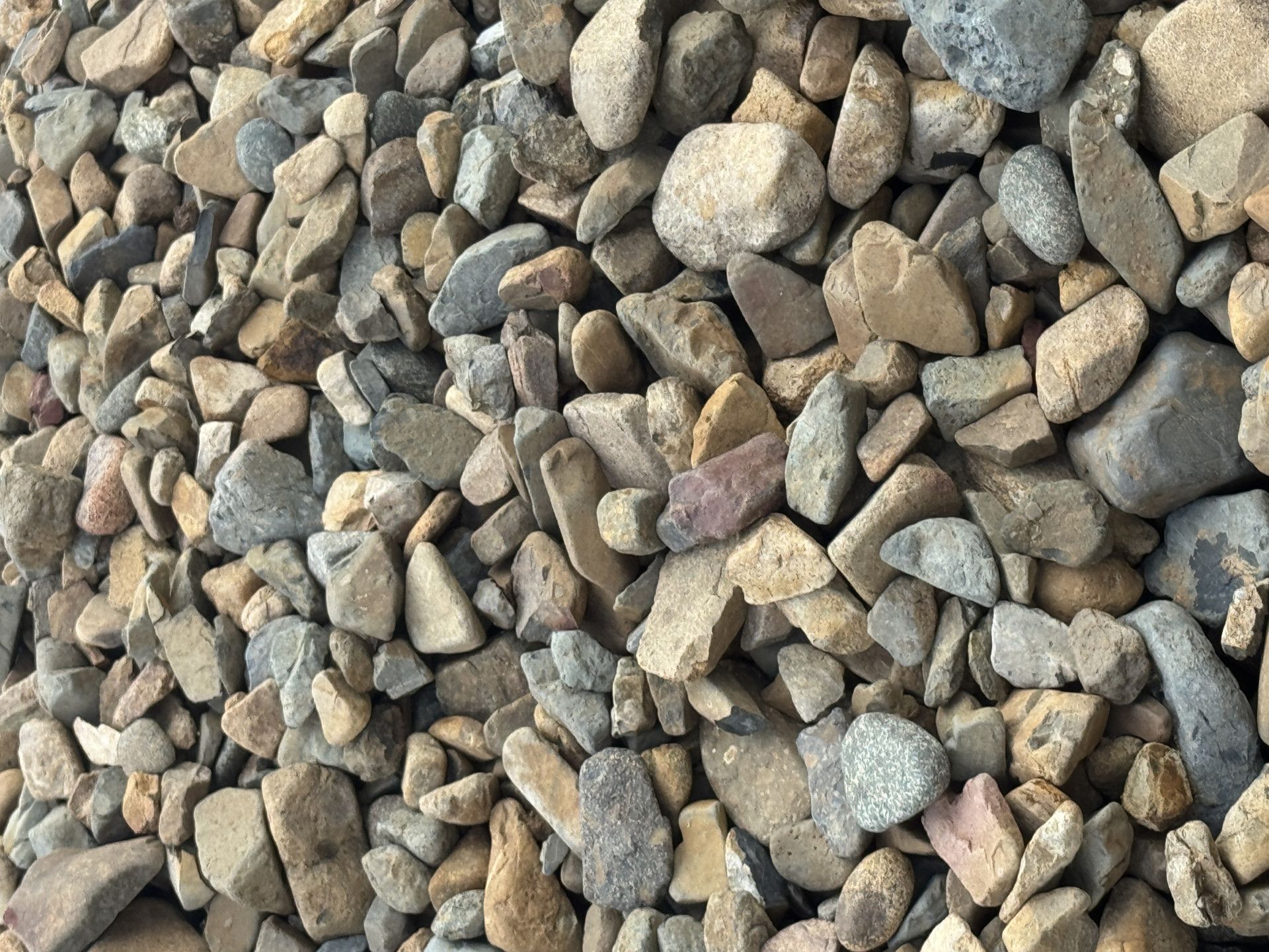 a hand picking up rocks — W Wall & Sons in Nebo, QLD