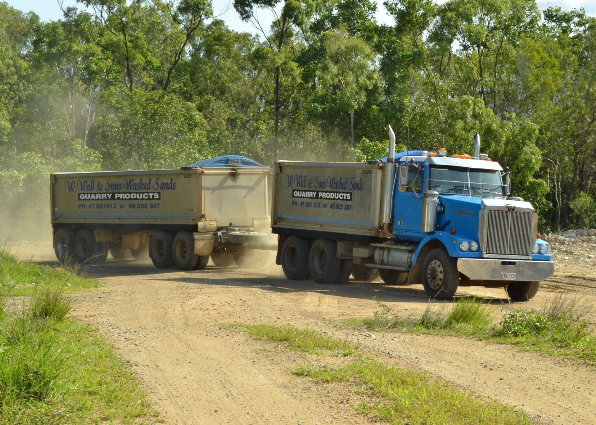 a truck on a dirt road surrounded by grass and trees — W Wall & Sons in Nebo, QLD