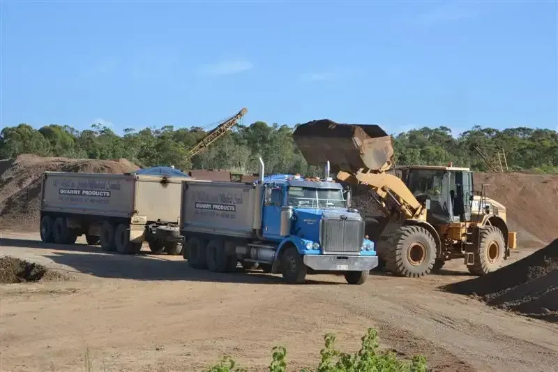 Dump Truck is Being Loaded With Dirt by a Bulldozer — W Wall & Sons in Nebo, QLD