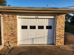 A white garage door with the number 714 on it