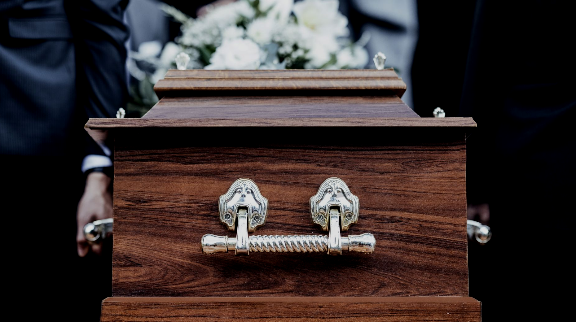 A man is standing in front of an open bible in a church.