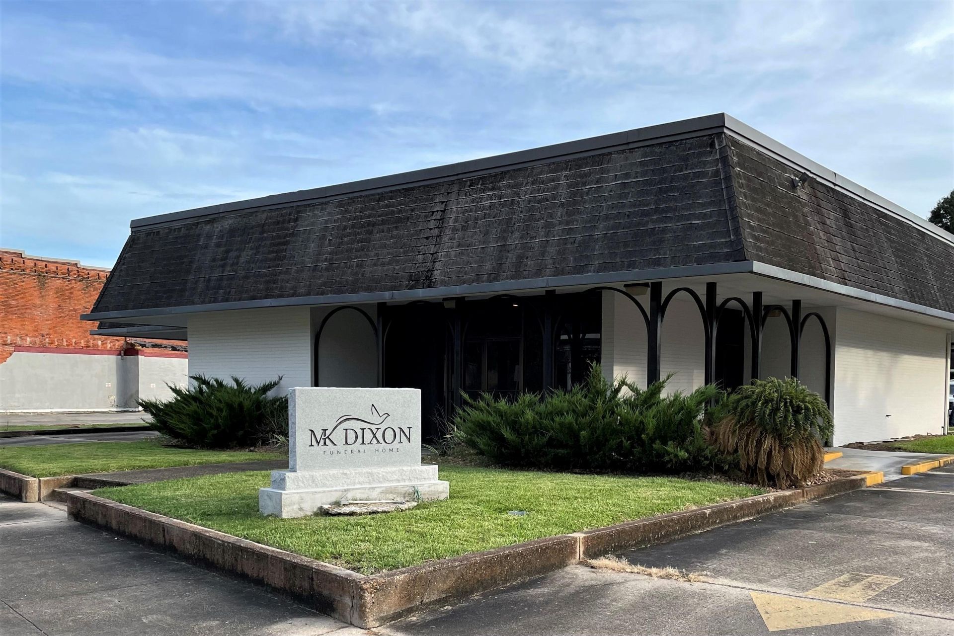 A large office building with a lot of windows on a sunny day.