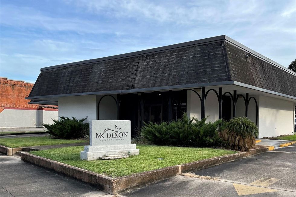 A large office building with a lot of windows on a sunny day.