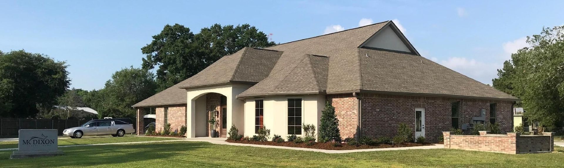 A large office building with a lot of windows on a sunny day.