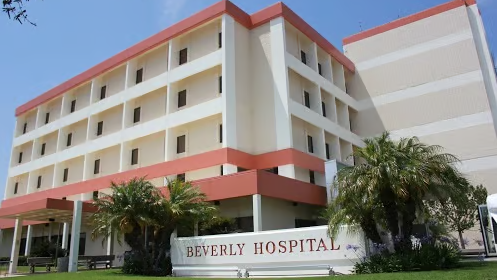 A large building with a sign that says Beverly Hospital.