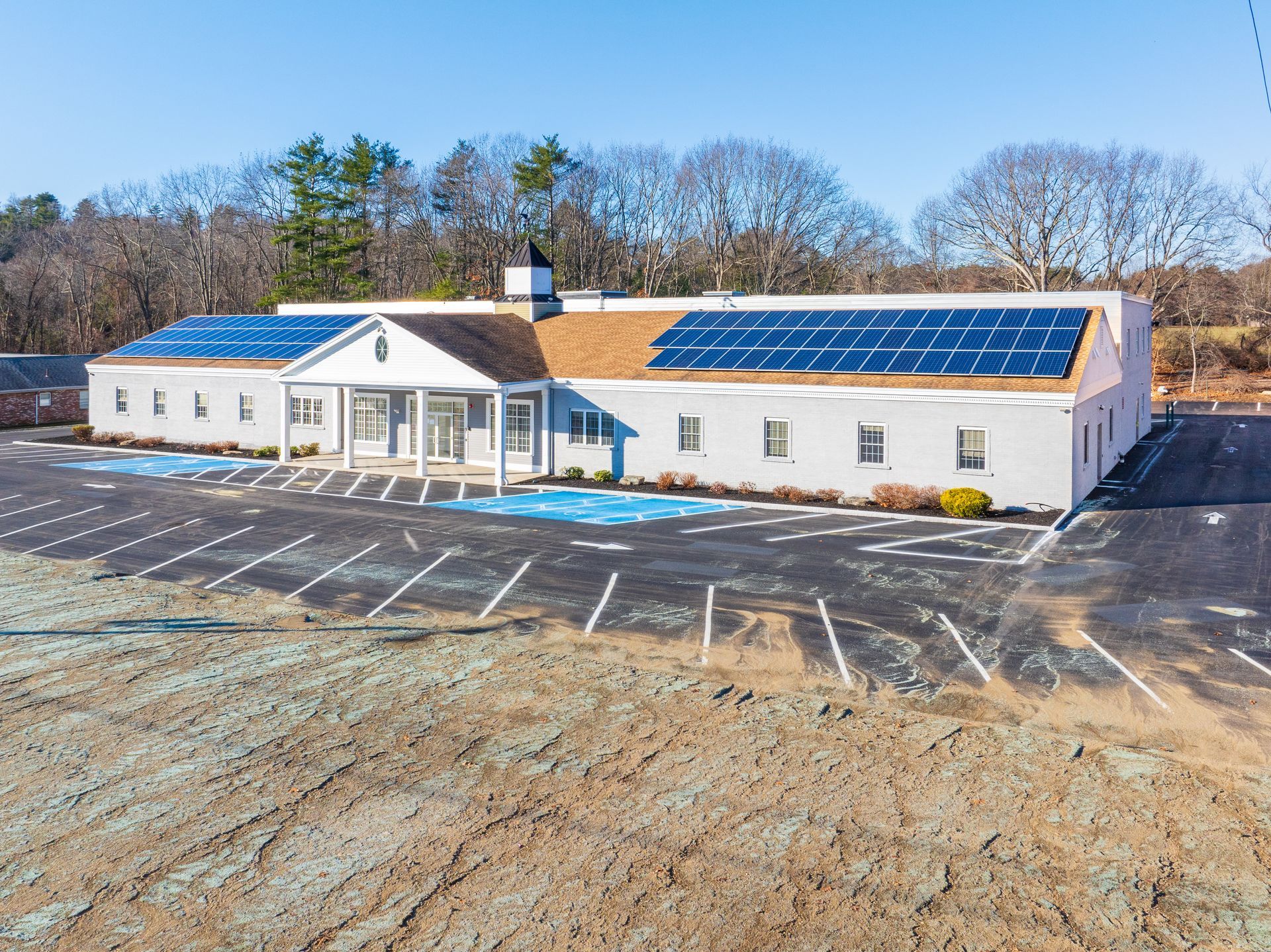 A large white building with solar panels on the roof.