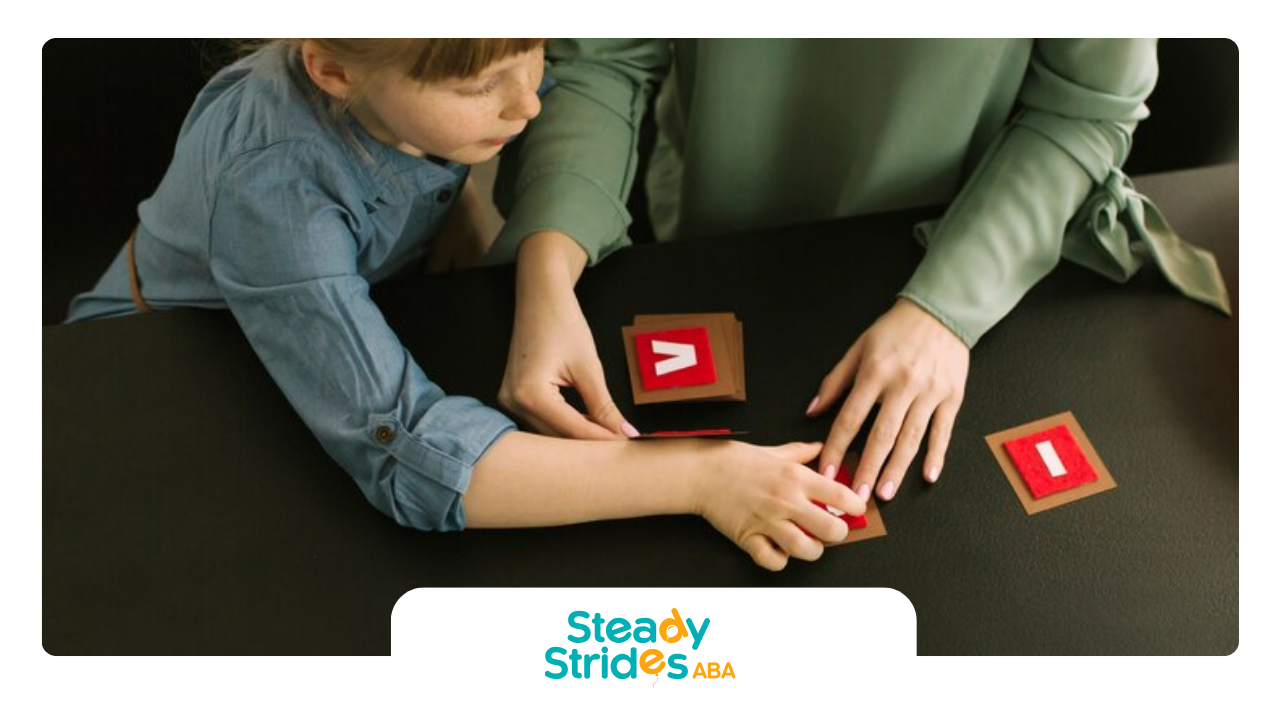 An RBT and a child are playing with cards on a table during ABA therapy session.
