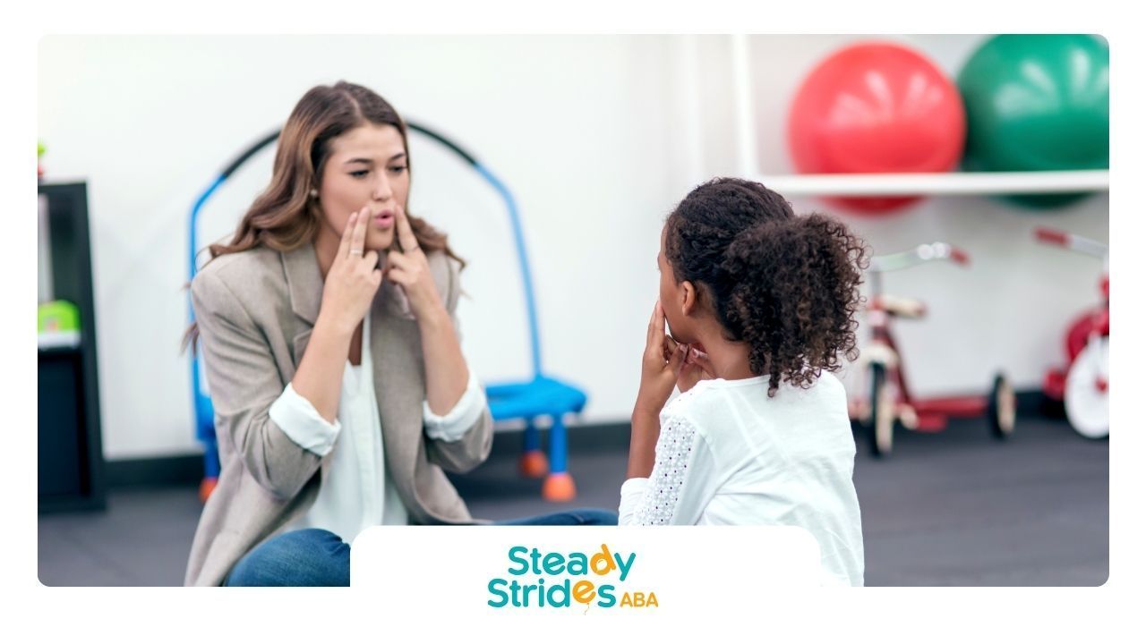 A woman is talking to a little girl in a room.