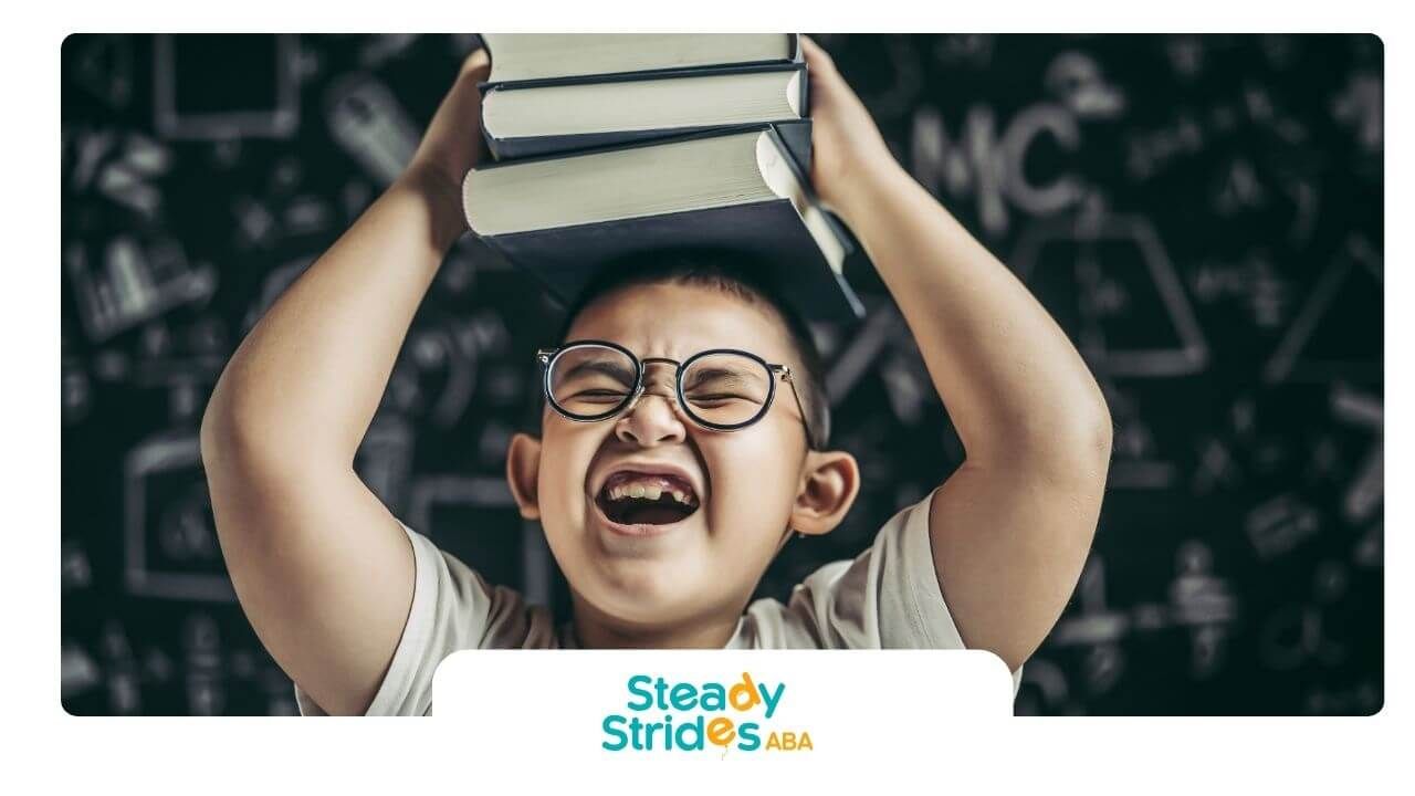 Autistic boy wearing glasses holding books on head and smiling, symbolizing learning, and growth.