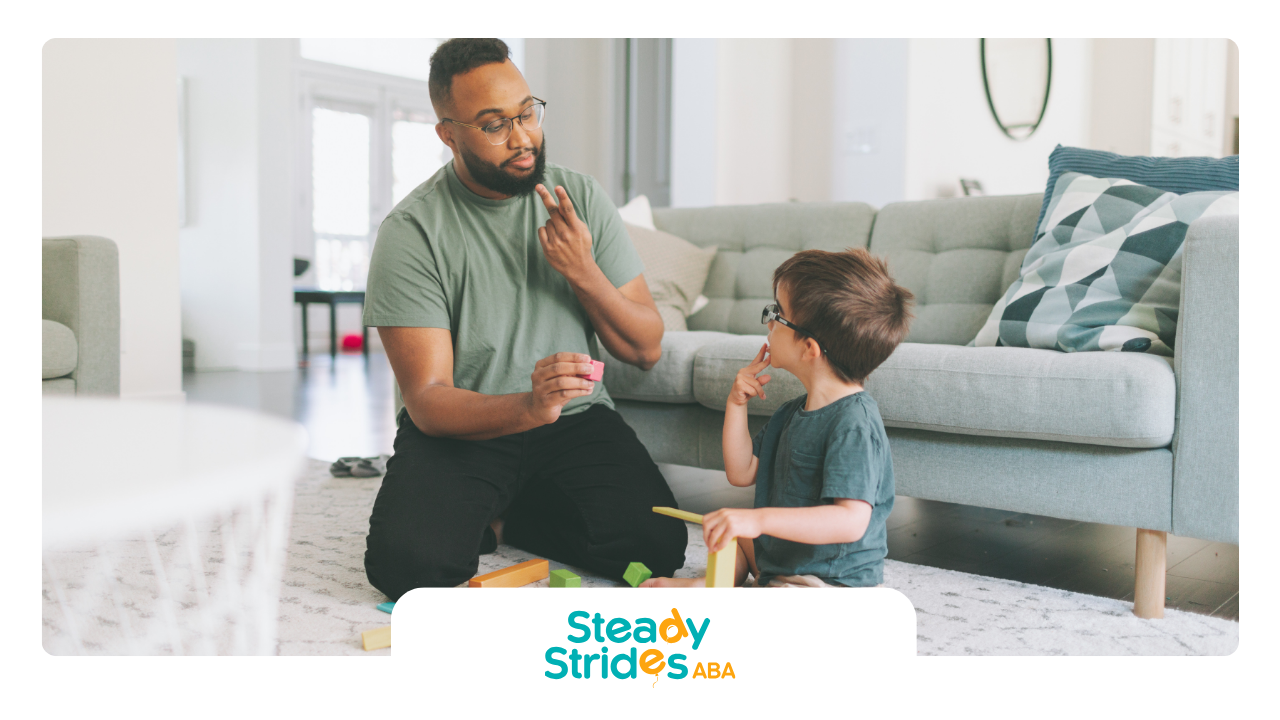 A man and a boy are playing with toys in a living room.