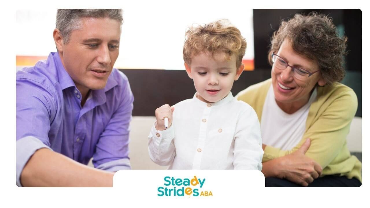 Therapist and autistic child draw together at home in a supportive family activity in Texas.
