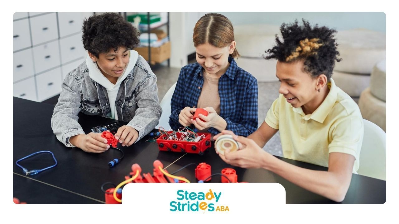 Three autistic teens building robotics project together, engaged in a hands-on STEM activity in TX.