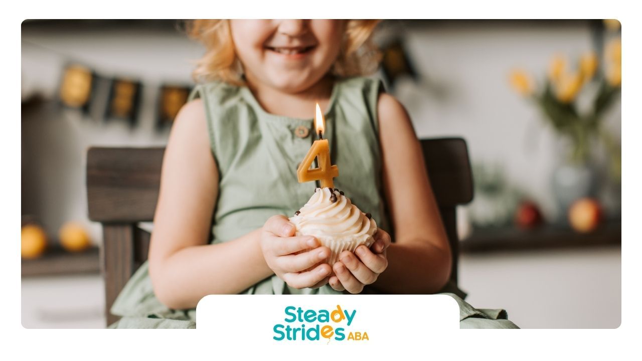Girl holding a cupcake with a lit 