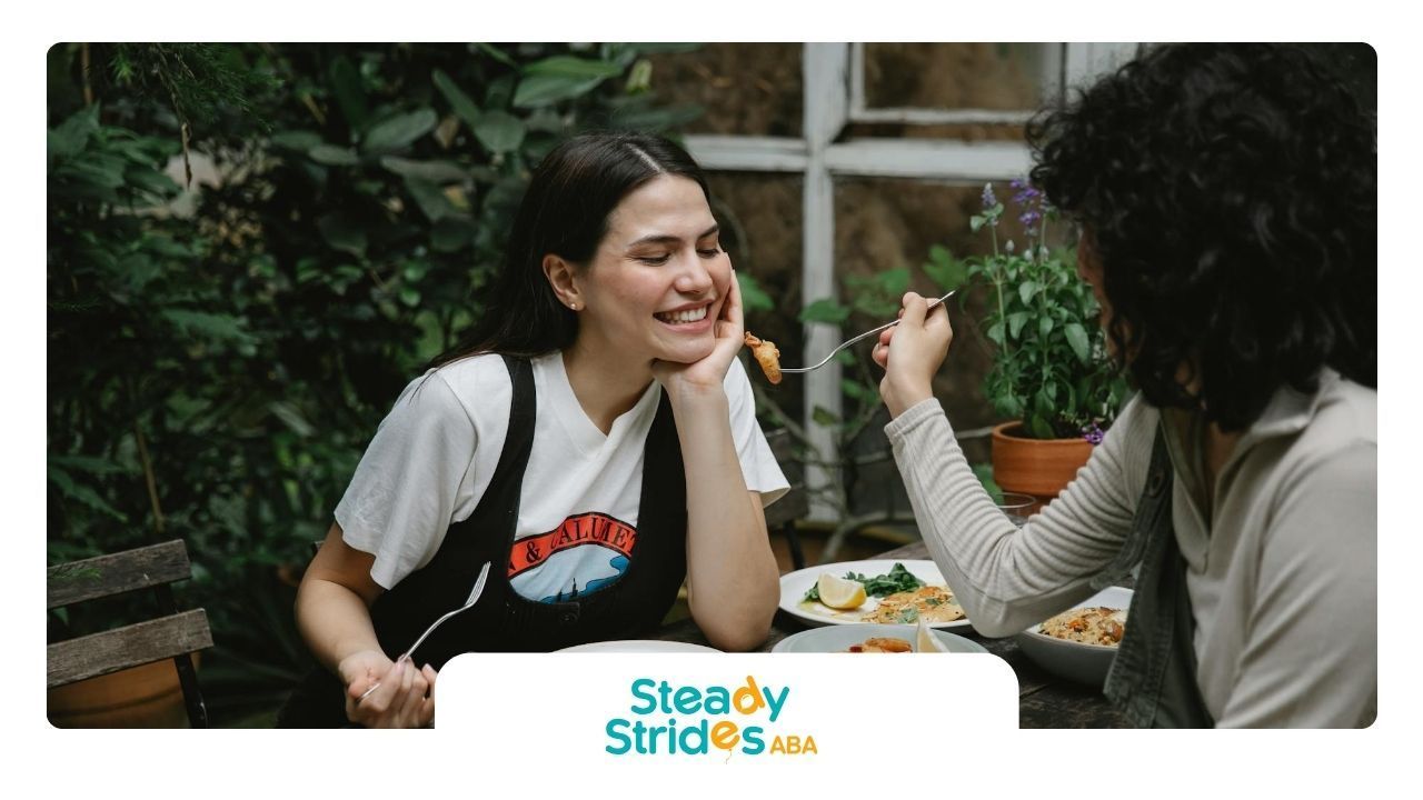Two autistic women enjoying a meal together, masking autism, at an outdoor restaurant in Texas.
