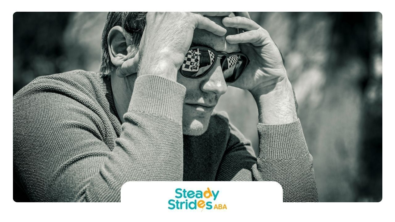 Black and white photo of an autistic adult experiencing shutdown with sunglasses on in Texas.