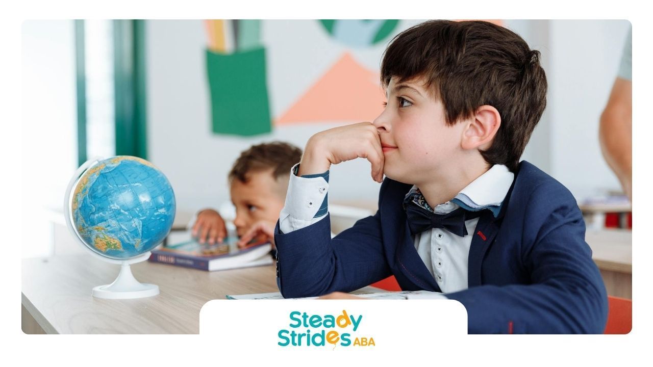 Autistic boys sitting at school desks, one daydreaming beside a globe in a bright classroom in TX.