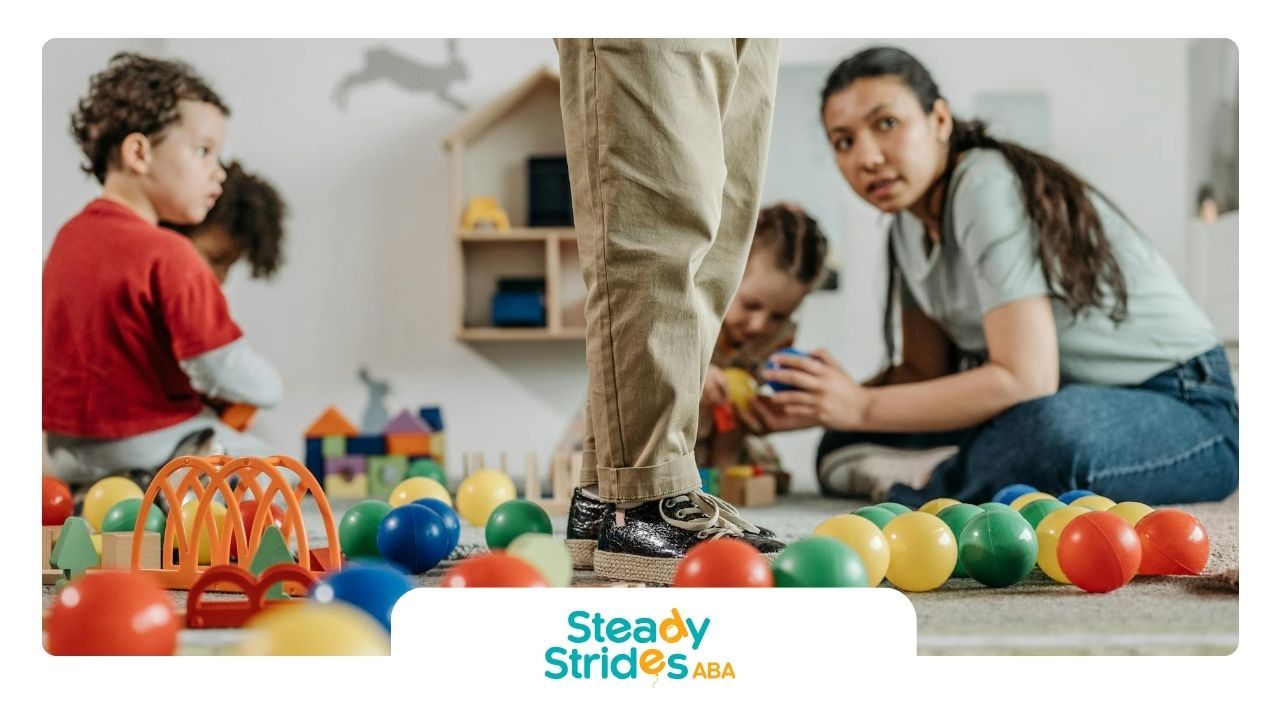 Children and ABA therapist playing with colorful balls and toys in a center-based 
ABA therapy in TX