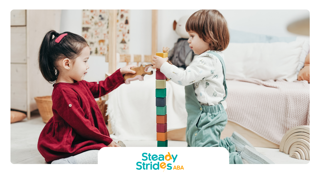 A boy and a girl are playing with wooden blocks in a room.