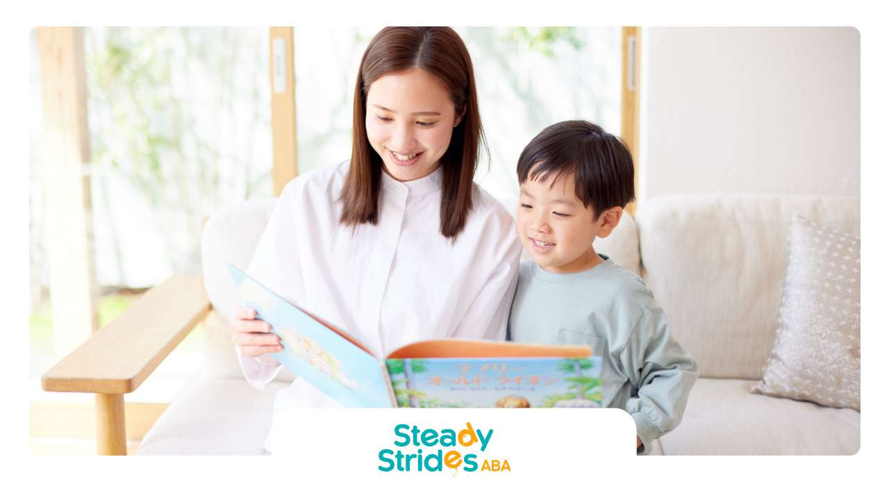 Woman and child reading a book on a couch, smiling indoors.