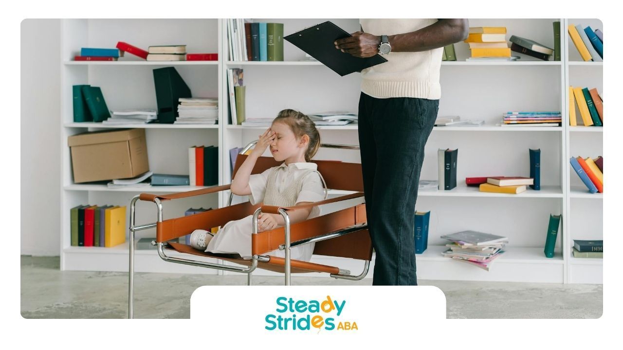 An autistic girl sitting on chair covering face, while a BCBA is evaluating her for autism in TX.