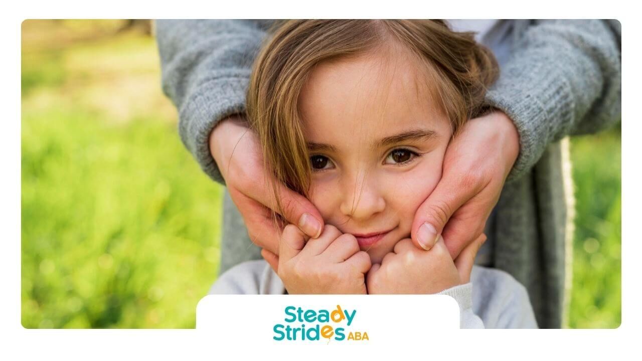 A child with autism is looking at the camera.