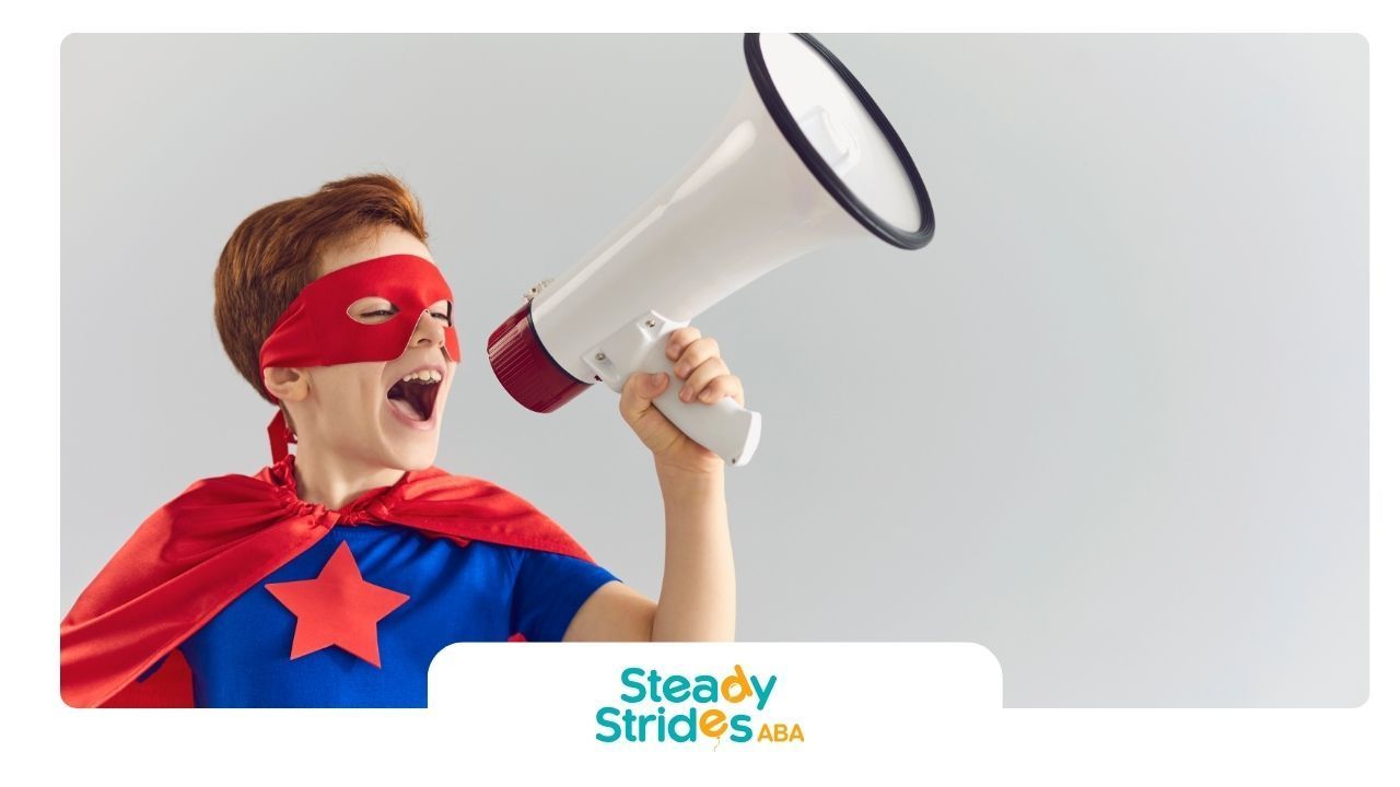 Boy in superhero costume shouting into a megaphone.