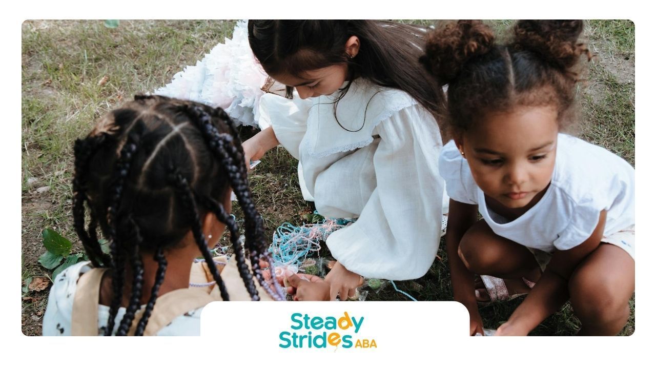 Three young autistic girls playing outdoors on the Texas grass, gathering objects with curiosity.